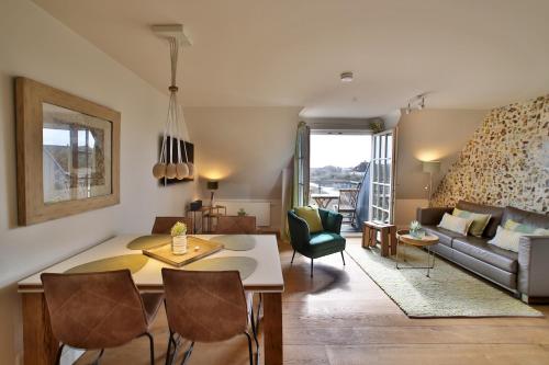 a living room with a table and chairs and a couch at ApartHotel Seepferdchen in Hörnum