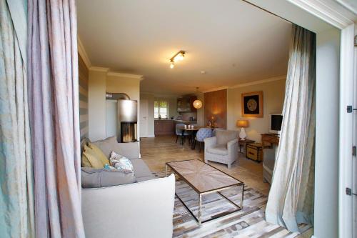 a living room with a couch and a table at ApartHotel Seepferdchen in Hörnum