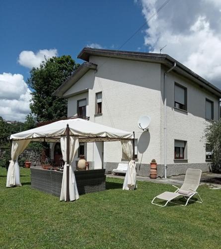 a tent and chairs in front of a house at A CASA DI MATTEO in Brugnato