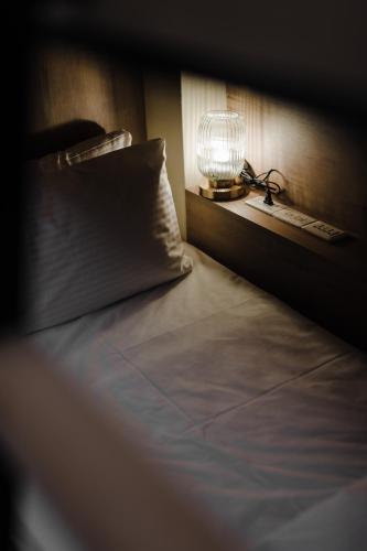 a bedroom with a bed with a lamp on it at Inns Hotel in Kaohsiung