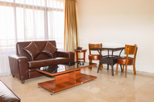 a living room with a leather couch and a table at Al Jamal Suites in Amman