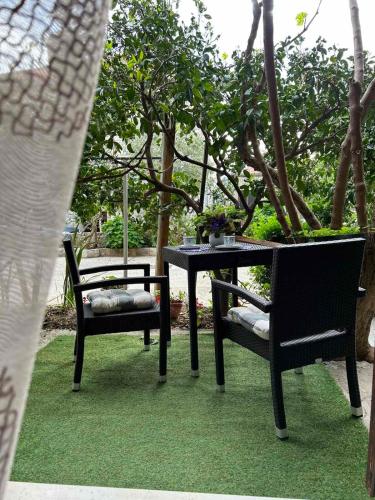 two chairs and a table and a table and chairs at Guesthouse Klečak in Cavtat