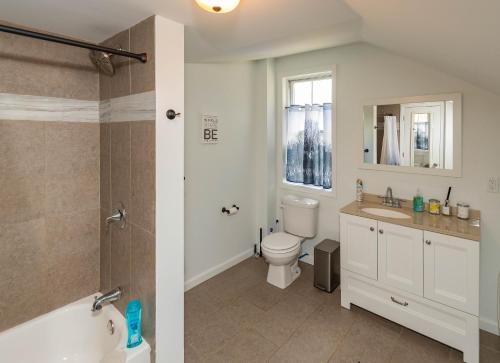 a bathroom with a tub and a toilet and a sink at Cozy Creek Inn in North Branch