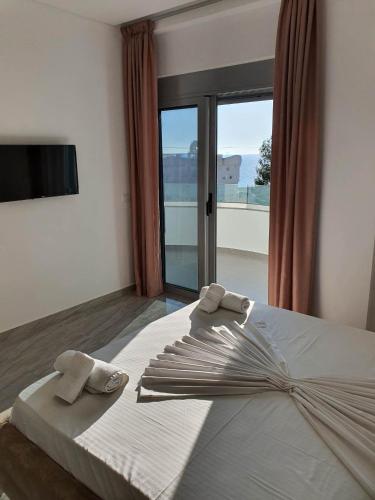 a bedroom with a bed with towels on it at The Sunset View in Sarandë