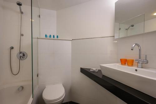 a bathroom with a toilet and a sink and a shower at Riviera by Isrotel Collection in Eilat