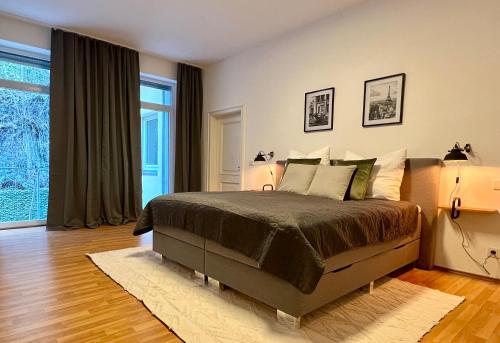 a bedroom with a large bed with two lamps at VonMos City Apartments in Traben-Trarbach