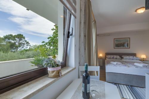 a bedroom with a bed and a window at Apartments Dado in Poreč