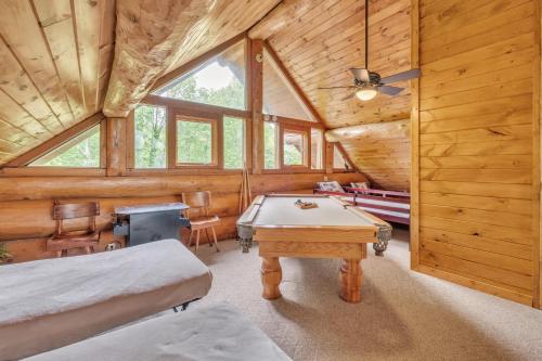 a room with a pool table in a log cabin at Royal Views - Private Mountain Top Cabin cabin in Gatlinburg
