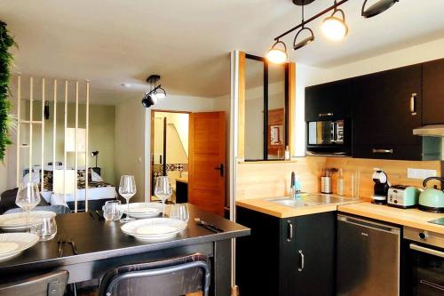 a kitchen with sinks and wine glasses on the counter at Studio le St O-Zone in Angoulême