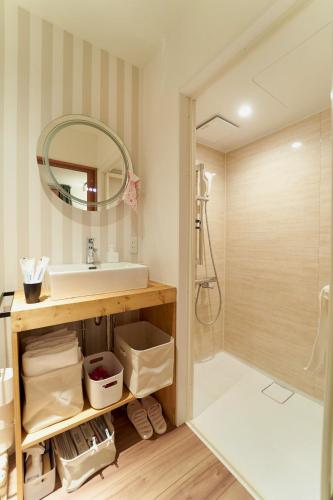 a bathroom with a sink and a mirror at THE LOBS, RUSUTSU in Kimobetsu