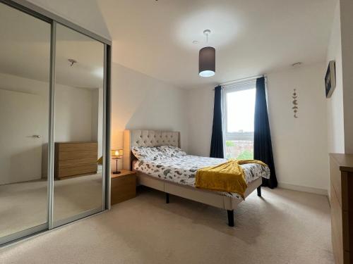 a bedroom with a bed and a glass shower at Modern 2BR 2BA Apt wParking Sleeps 6 Comfortably in London