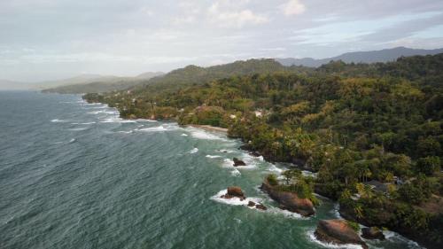 an island in the middle of the water with trees at Easy Breezy in Blanchisseuse