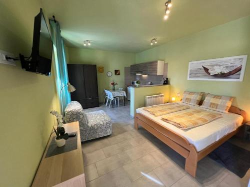 a bedroom with a bed and a living room at APARTMA JURICICH in Portorož