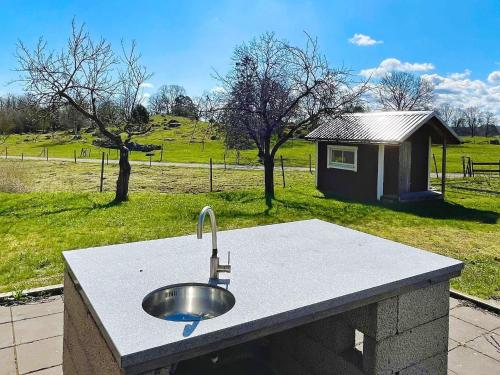 a sink on a stone counter in front of a field at 9 person holiday home in Mörlunda-By Traum in Mörlunda