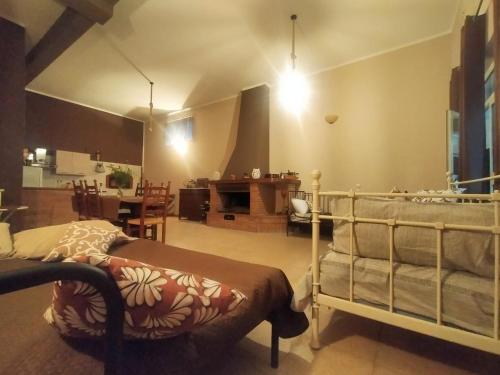 a living room with a bed and a dining room at Loft, Il Giardino Sabino in Palombara Sabina