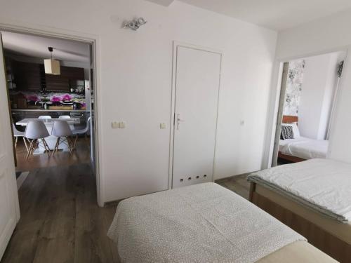 a bedroom with two beds and a dining room at Kaszubskie Zacisze in Chmielno