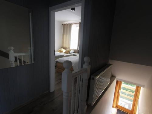 a view of a bedroom with a bed and a mirror at Kaszubskie Zacisze in Chmielno