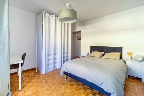 1 dormitorio con cama, escritorio y mesa en BEAU T3 grand balcon plage/calanques/Vieux Port en Marsella