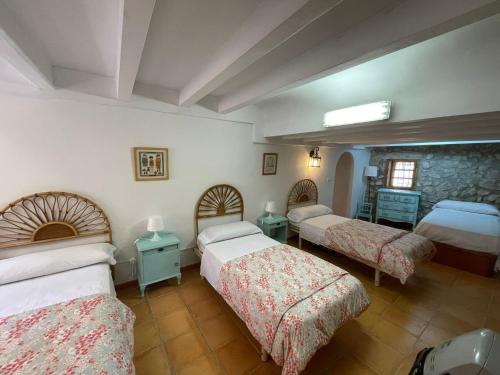 Penáguila的住宿－Casa Rural El Molí - Penáguila，一间卧室设有两张床和石墙
