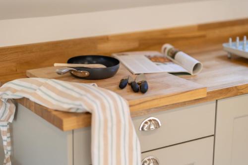 a kitchen counter with a cutting board and a book at Drifter's Loft in York