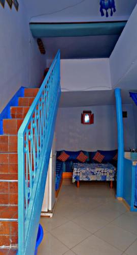 a room with a staircase with a blue stair railing at The blue in Chefchaouen