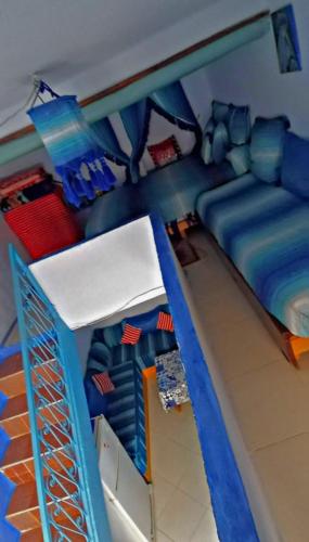a lego room with a bed and a couch at The blue in Chefchaouen
