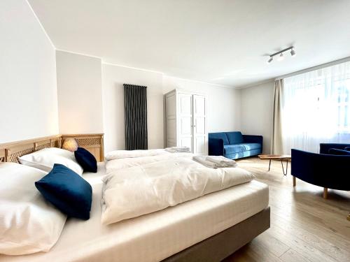 a bedroom with two beds and a blue couch at Willa Mandala in Dziwnówek
