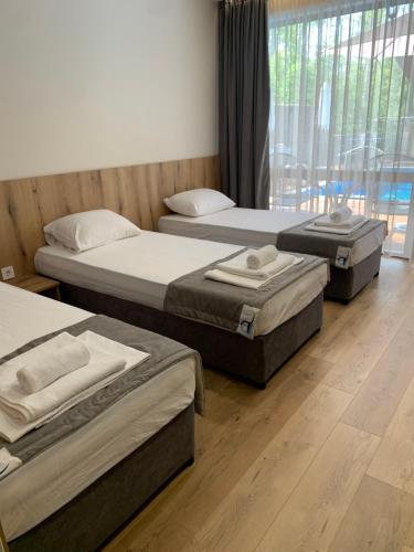 three beds sitting in a room with at Park and pool studios in Nesebar