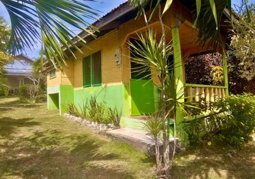 a house with green and yellow paint on it at La Villa Alta in Siquijor