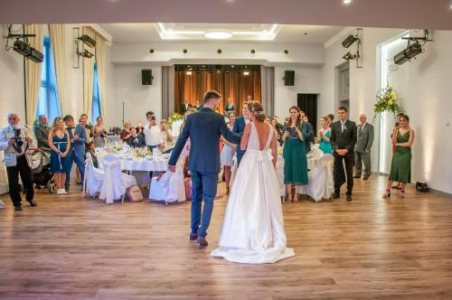 a bride and groom walking down the aisle at their wedding at Salón MISSEN in Trenčianske Teplice