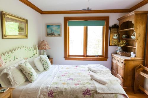 a bedroom with a bed and a window at Honey Maple Grove BnB in Bedford