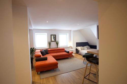 a living room with a couch and a bed at Apartament Rynek N°21 in Gliwice
