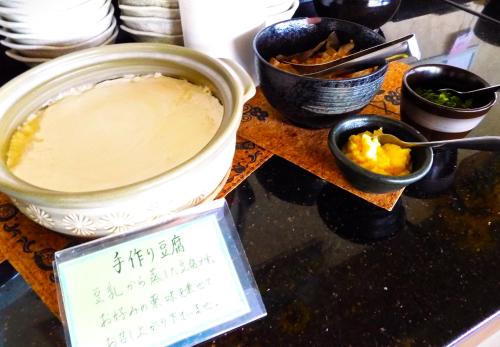 Breezbay Seaside Resort Matsushima في ماتسوشيما: طاولة مع وعاء من الطعام وعلامة