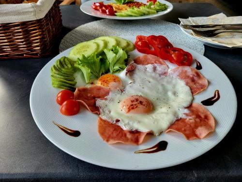 a plate of food with eggs and vegetables on a table at Salón MISSEN in Trenčianske Teplice