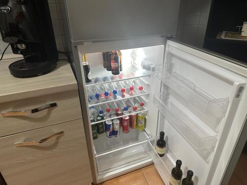 an open refrigerator filled with lots of drinks at Vanvitelli Home in Caserta