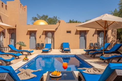 a villa with a pool and chairs and a resort at Taj Atlas Wellness Boutique Hôtel & Spa in Amizmiz
