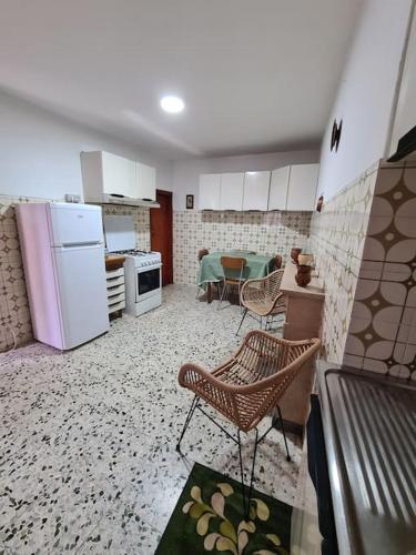 a kitchen with white appliances and a table and chairs at Nonna Dorina in Pietrabbondante