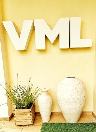 two vases sitting next to a wall with the wordwx at Villa Maria Luisa in Cagliari