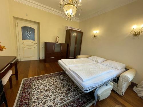 a room with a bed and a table and a room with a rug at Apartma Premium in Karlovy Vary