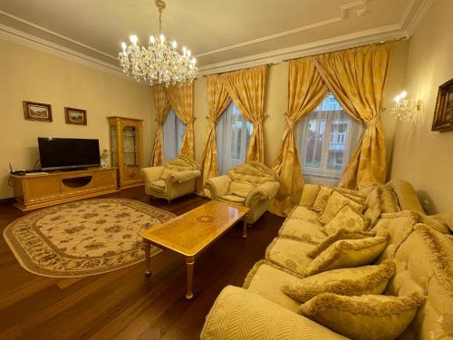 a living room with a couch and a table at Apartma Premium in Karlovy Vary