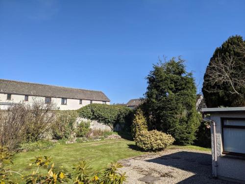 a garden with a building and a garage at Applegrove, perfect 2 bed bungalow, Fortrose in Fortrose