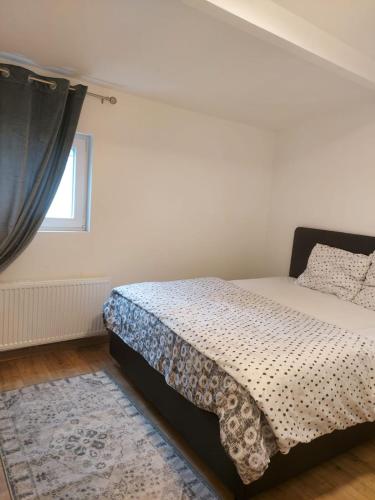 a bedroom with a bed and a window at Maison fontaine du saxophone in Dinant