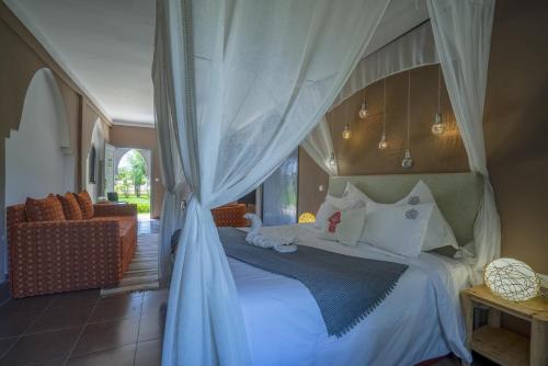 a bedroom with a bed with a canopy at Taj Atlas Wellness Boutique Hôtel & Spa in Amizmiz