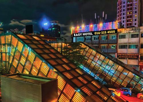 a lit up building in a city at night at ESSY Hotel KL Sentral in Kuala Lumpur