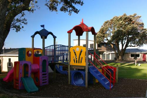 a group of playground equipment in a park at Belt Road Seaside Holiday Park in New Plymouth
