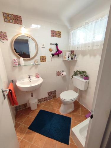 a bathroom with a toilet and a sink at Apartman Valentin in Siófok