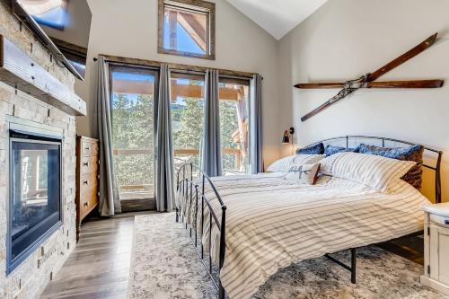 a bedroom with a bed and a fireplace at Seasons 1825 in Keystone
