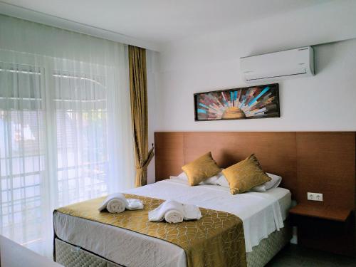 Postel nebo postele na pokoji v ubytování Ada Apart Hotel Göcek