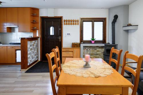 a kitchen with a wooden table with a candle on it at Domek na zacisznych obrzeżach Kazimierza Dolnego in Kazimierz Dolny