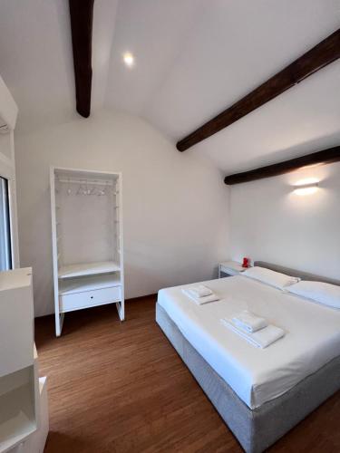 a bedroom with a white bed and a shelf at Skyline Silence Suite in Milan